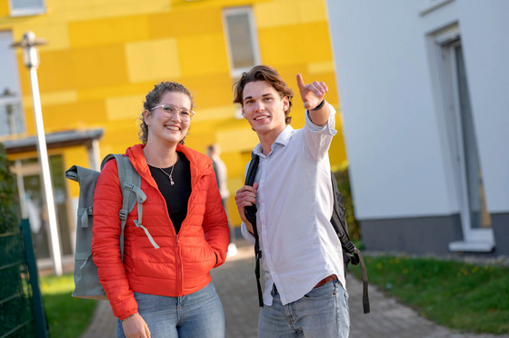 Lingen bietet Studierenden jede Menge Leben, ganz egal ob Freizeit, Kultur oder Ausflüge in die Region. Zwei Studierende stehen vor dem Wohnheim in Lingen.